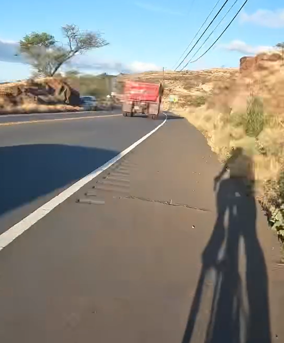 A photo of a large truck passing Hyun in Maui